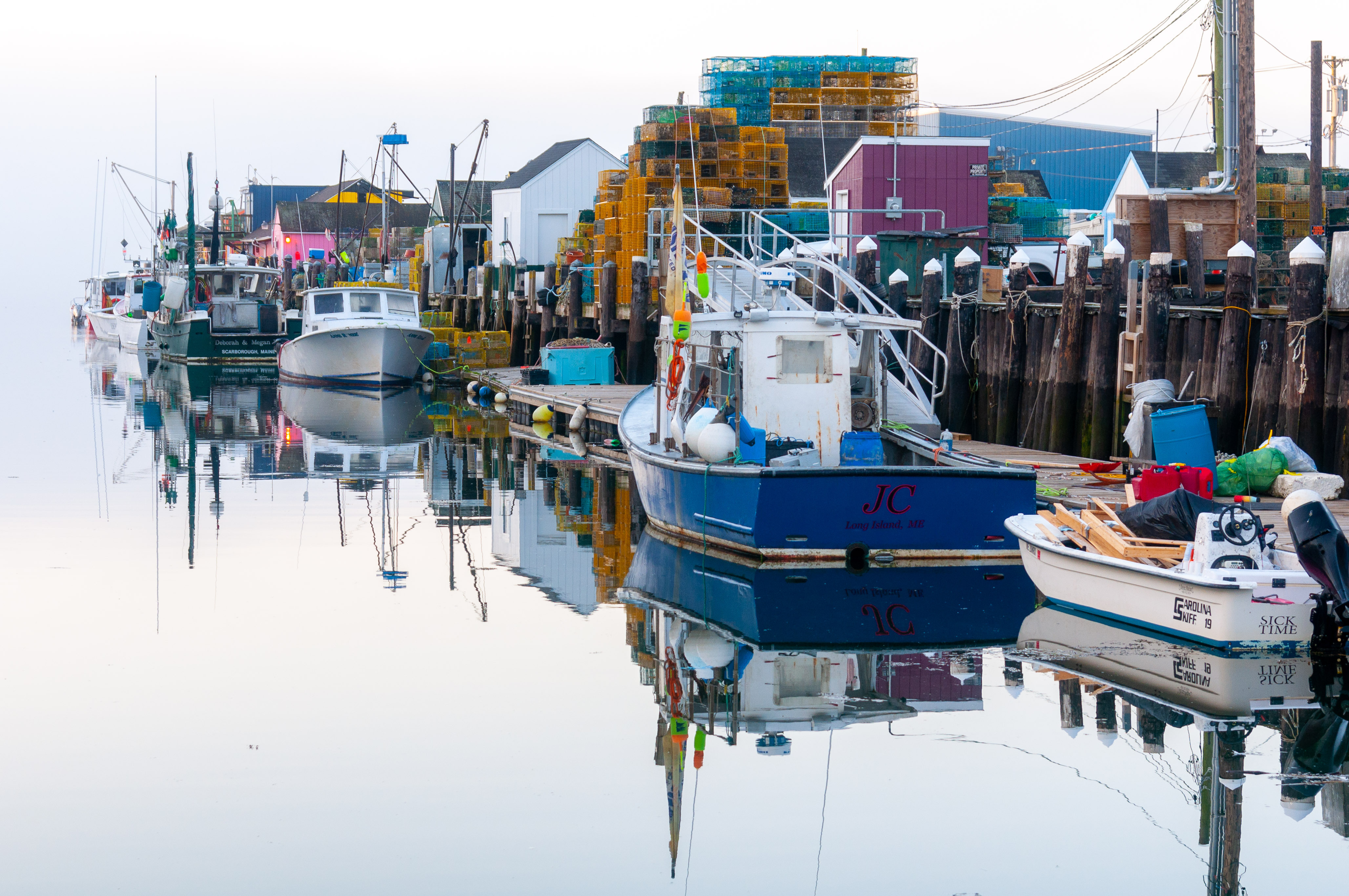 Lobster and fishing boats line historic Widgery Wharf in Portland, Maine. 